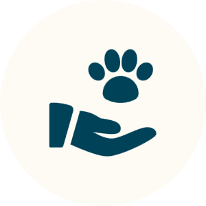 A hand holding a paw symbol, representing pet care.