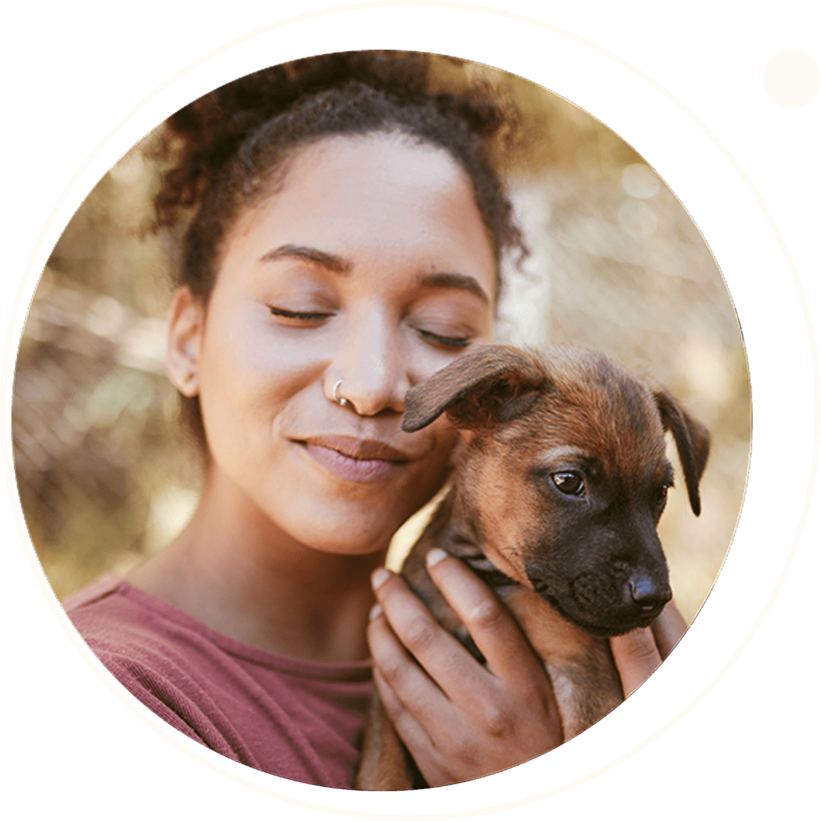 A woman lovingly hugs a brown puppy outdoors.
